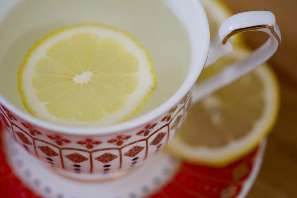 Lemon tea or lemon water a cup of hot water with fresh lemon at erling.yoga