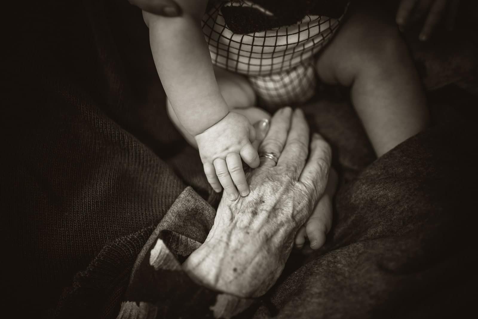ageing and yoga an image of an old persons hand and babies foot to illustrate the ageing process and yoga for erling.yoga