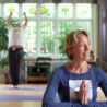 smiling woman with hands pressed together in namaste for an Isle of Wight yoga retreat with Erling at erling.yoga
