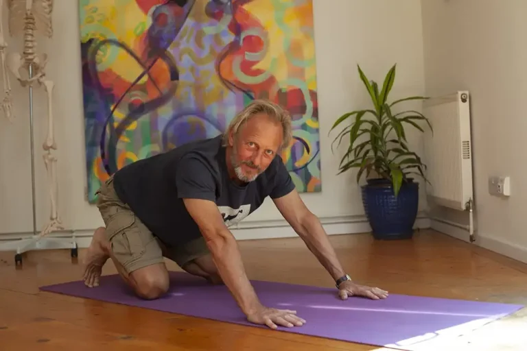 man in resting hands and knees in yoga foundation course