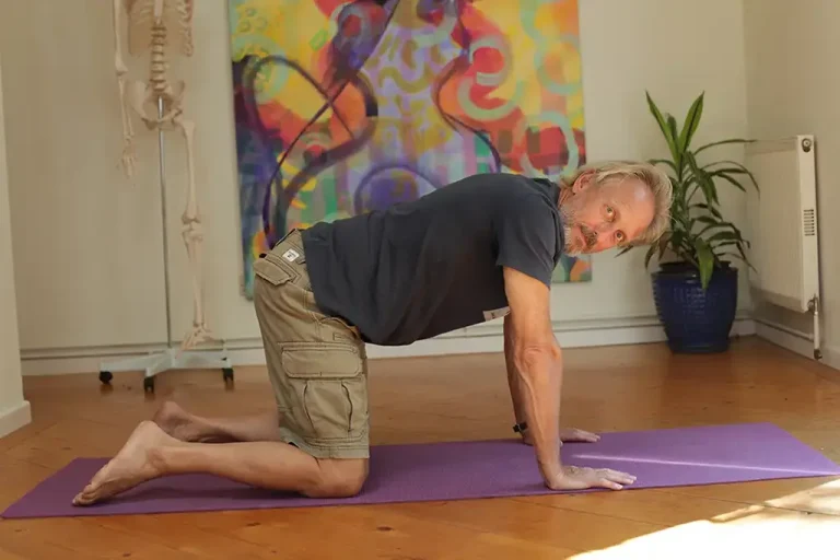 man on hands an knees in yoga foundation course