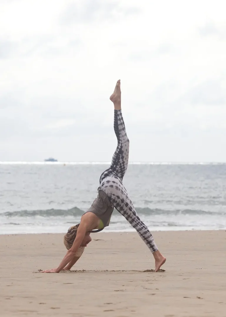 woman with one leg in the air for yoga foundation course