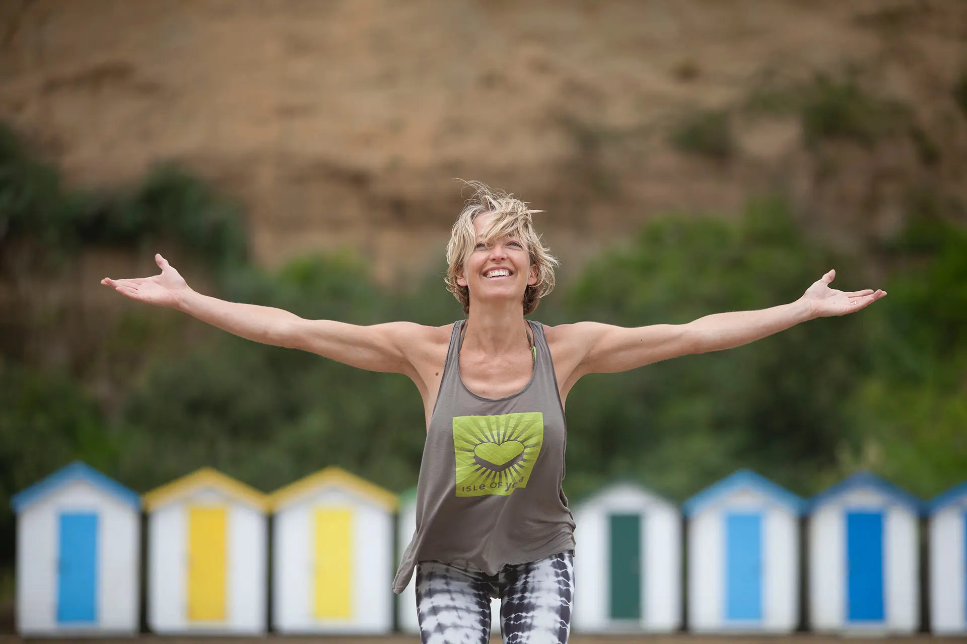 yoga images of elaine with arms out wide smiling at the camera