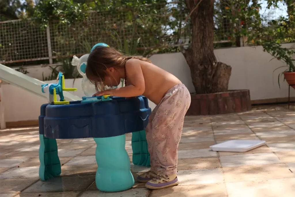 young girl bent over a play station outside for a blob on yoga poses