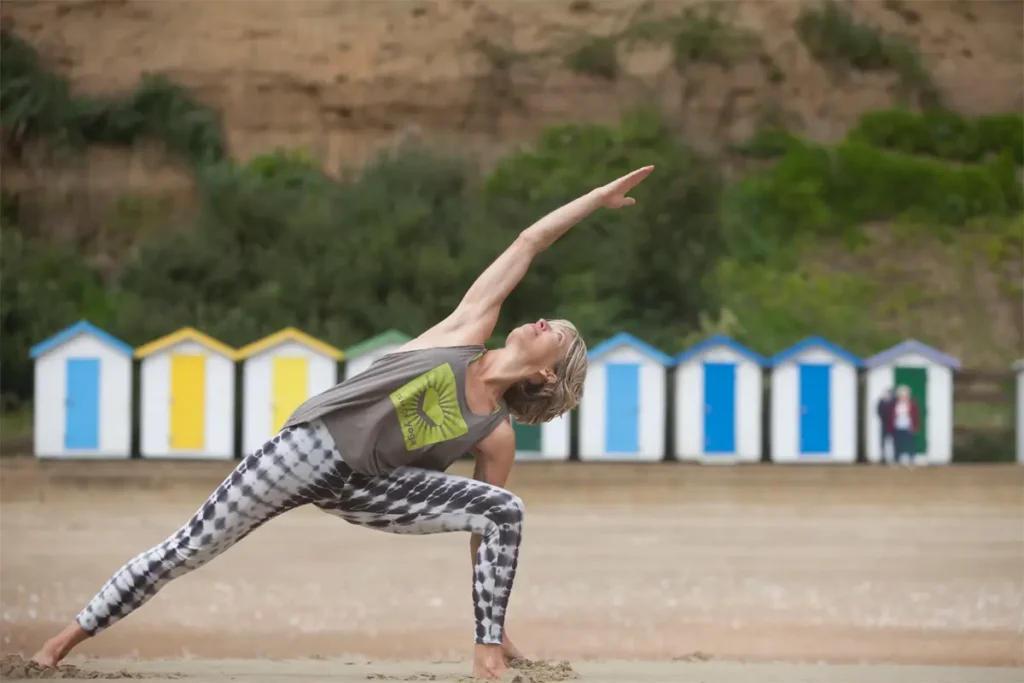 woman in yoga pose on the beach