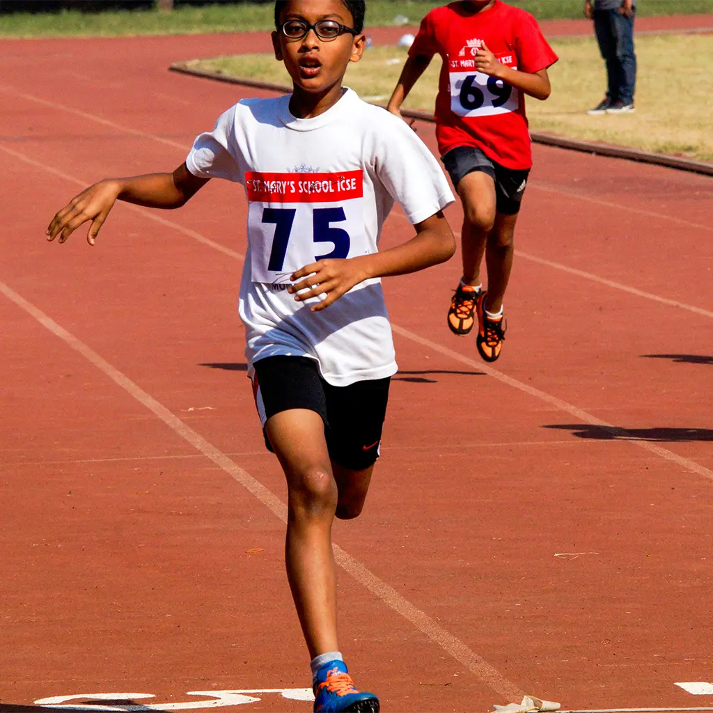 boy running on track to demonstrate the idea of rotation in yoga poses